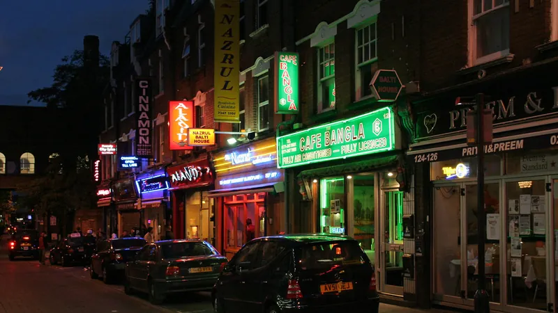 Indian and Bangladeshi restaurant signs on Brick Lane at night