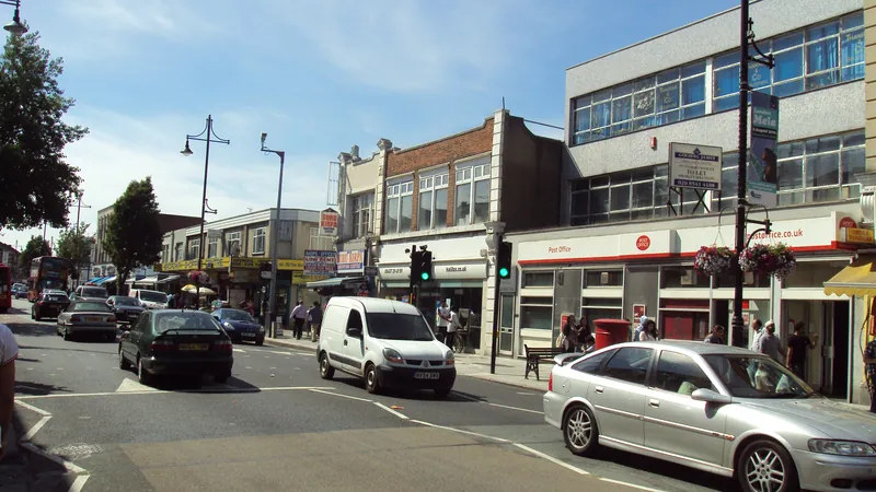 Traffic and independent shops along The Broadway in Southall